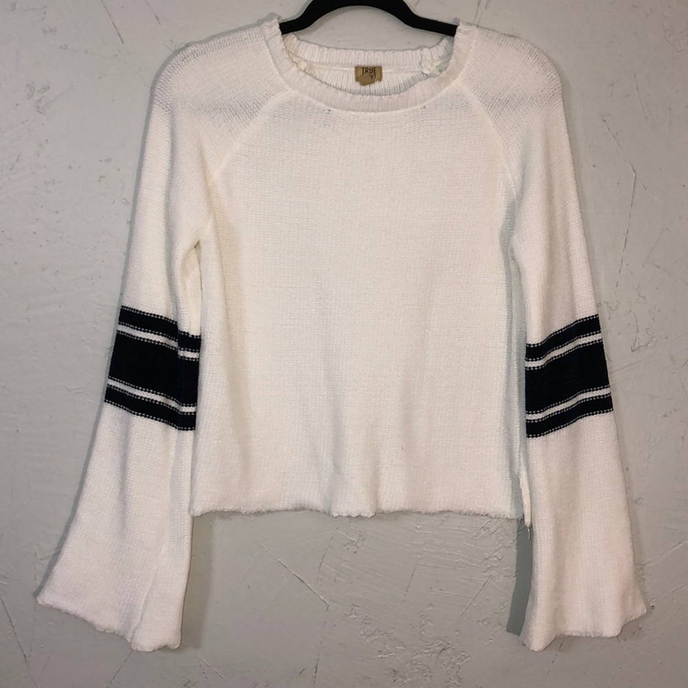 White sweater with navy detail on sleeves